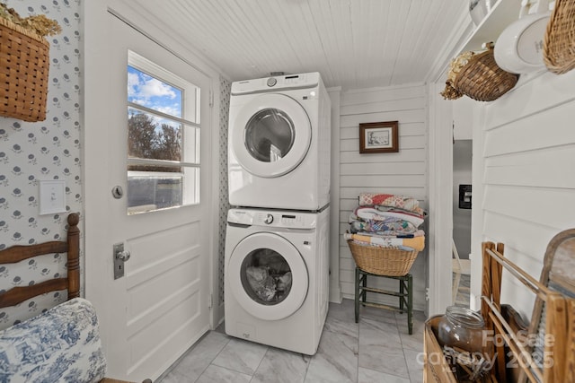 washroom featuring stacked washer / drying machine and wood ceiling