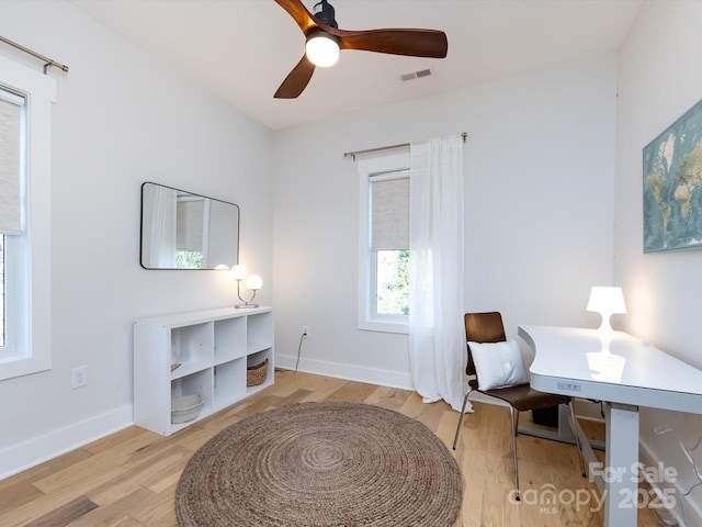 office space with ceiling fan and light wood-type flooring