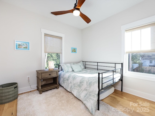 bedroom with ceiling fan and light hardwood / wood-style flooring