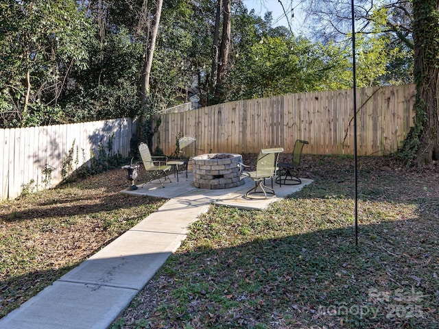 view of yard featuring a patio and an outdoor fire pit