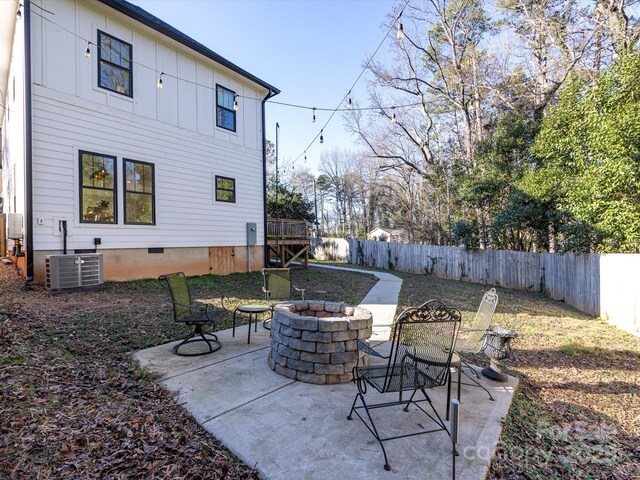 view of patio / terrace featuring cooling unit and an outdoor fire pit