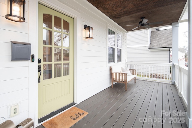 wooden terrace featuring covered porch and ceiling fan