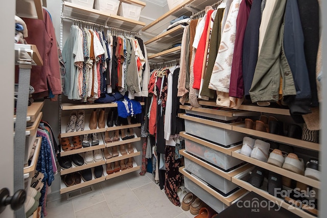 spacious closet featuring light tile patterned floors