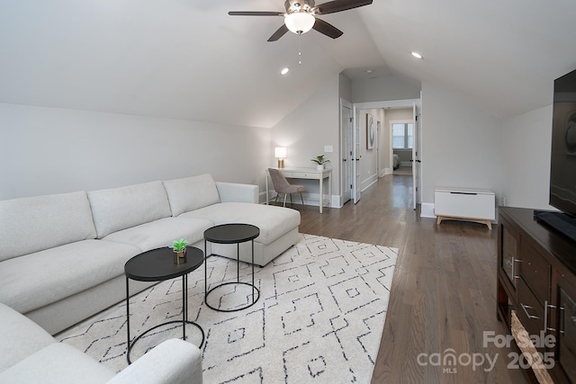 living room featuring ceiling fan, light hardwood / wood-style flooring, and lofted ceiling