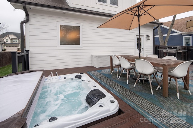 deck featuring grilling area and an outdoor hot tub