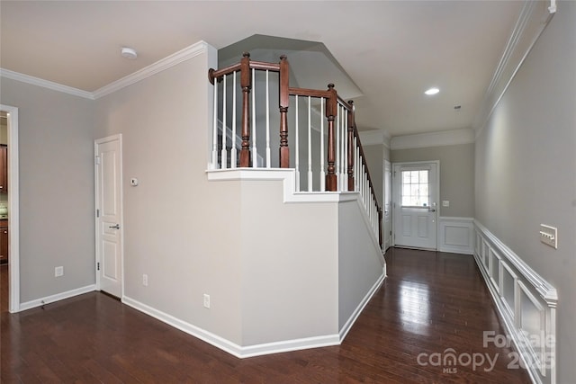 entrance foyer featuring dark hardwood / wood-style flooring and crown molding