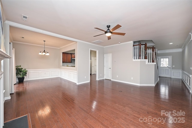 unfurnished living room with crown molding, dark wood-type flooring, and ceiling fan with notable chandelier