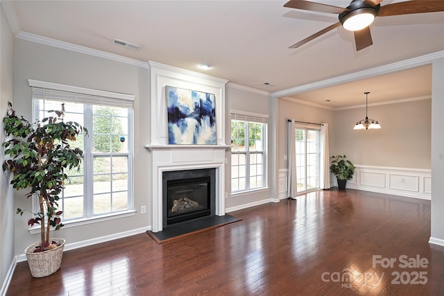 unfurnished living room featuring crown molding, dark hardwood / wood-style flooring, and ceiling fan with notable chandelier