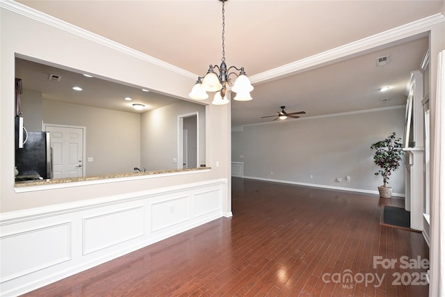 interior space with dark hardwood / wood-style flooring, ceiling fan with notable chandelier, and ornamental molding