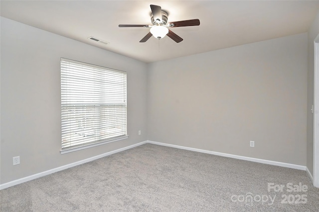 unfurnished room with ceiling fan and light carpet