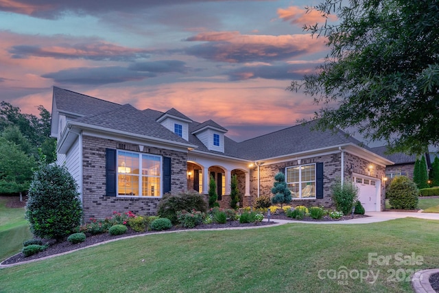 view of front of property with a lawn and a garage