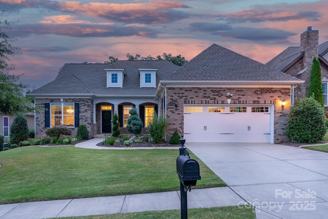 view of front of property featuring a yard and a garage