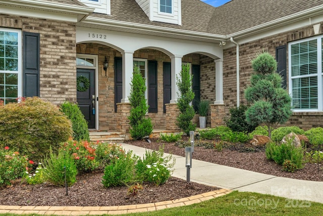 doorway to property featuring covered porch