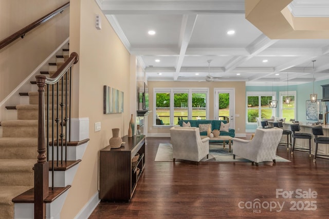 living room with coffered ceiling, ceiling fan, dark hardwood / wood-style floors, ornamental molding, and beam ceiling