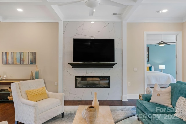 living room with coffered ceiling, dark hardwood / wood-style floors, ceiling fan, a premium fireplace, and beamed ceiling