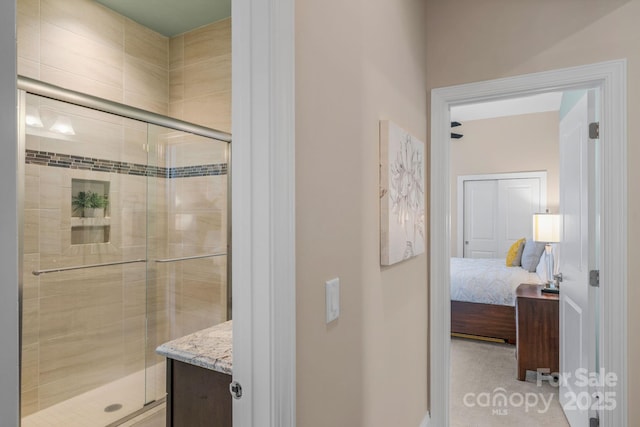 bathroom featuring vanity and an enclosed shower