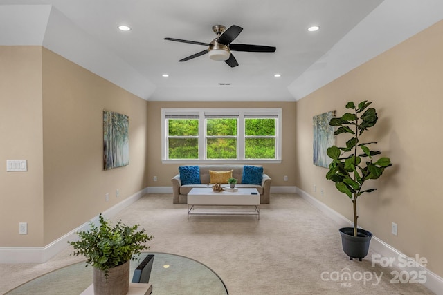 sitting room featuring ceiling fan, light colored carpet, and vaulted ceiling