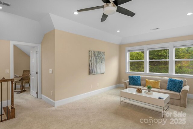 sitting room with ceiling fan, light colored carpet, and lofted ceiling