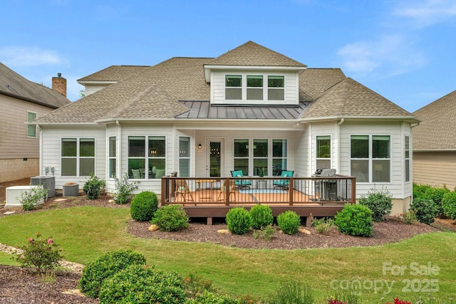 rear view of house with a lawn, central air condition unit, and a wooden deck