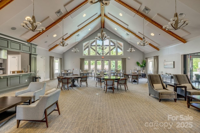 carpeted dining space with high vaulted ceiling and a chandelier