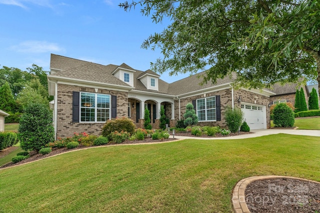 cape cod home featuring a front yard and a garage