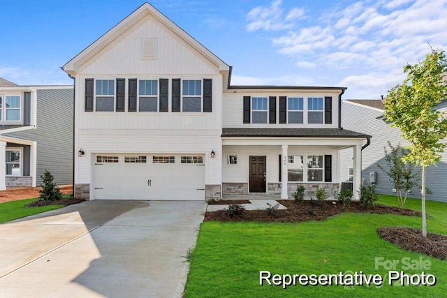 view of front of property featuring a front lawn and a garage