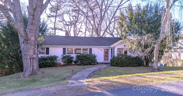 ranch-style home with a front lawn