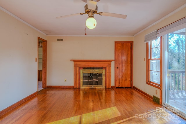 unfurnished living room with light hardwood / wood-style flooring, ceiling fan, and crown molding