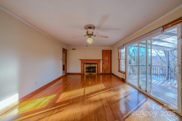 unfurnished living room featuring light hardwood / wood-style floors, ceiling fan, and crown molding