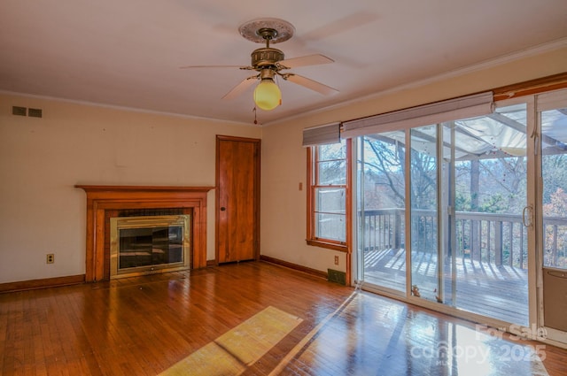 unfurnished living room with ceiling fan, crown molding, and wood-type flooring