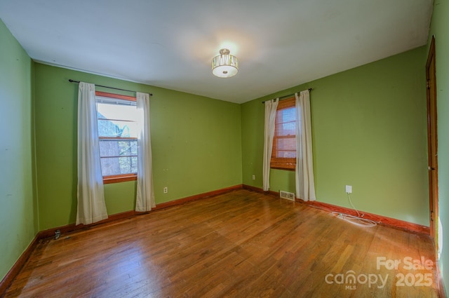 spare room with wood-type flooring