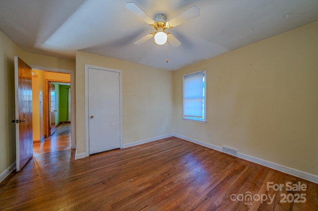 unfurnished room featuring ceiling fan and wood-type flooring