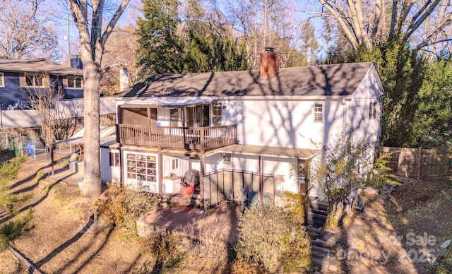 rear view of property with a wooden deck