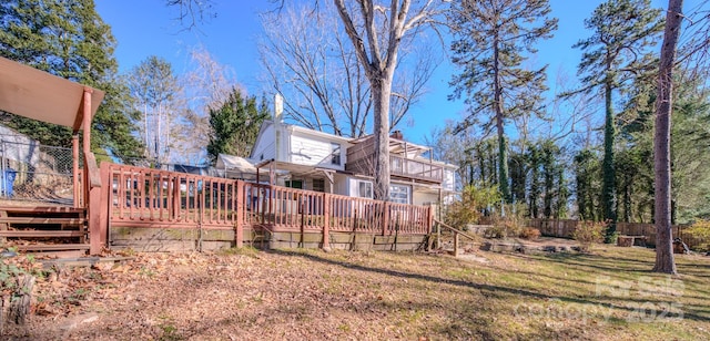 view of yard featuring a balcony and a deck