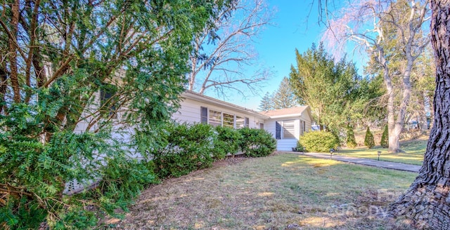 view of home's exterior with a yard