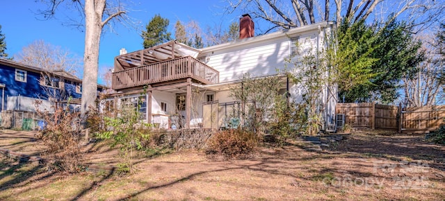 rear view of house with a wooden deck