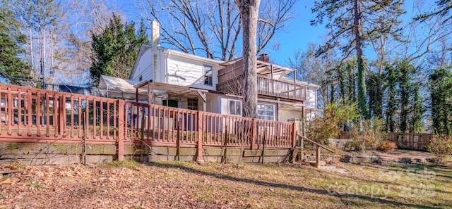 back of house with a wooden deck