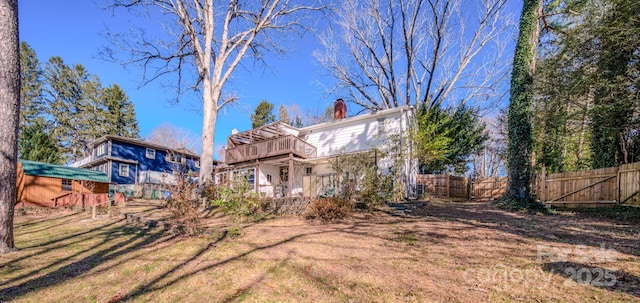 view of yard with a balcony and an outbuilding