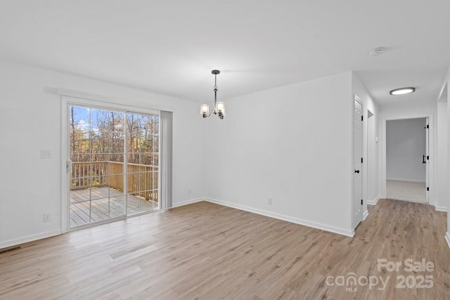 unfurnished dining area with a chandelier and light hardwood / wood-style flooring