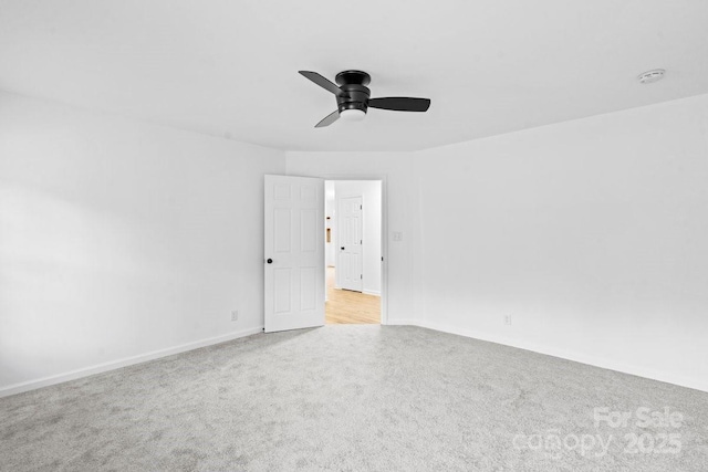 spare room featuring ceiling fan and light carpet