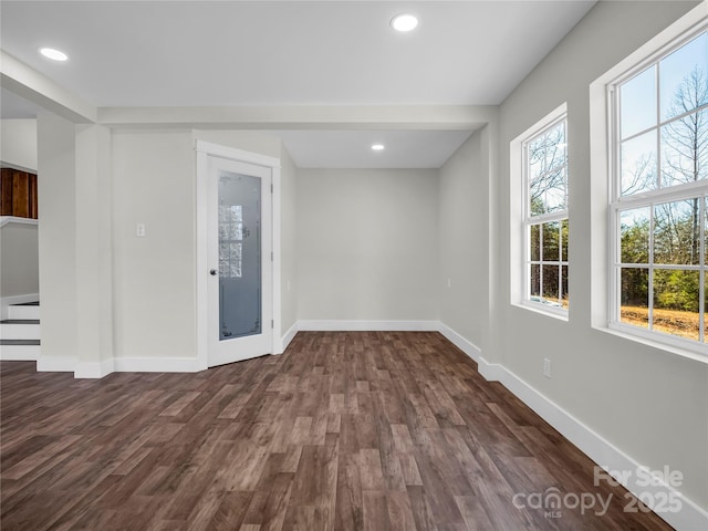 spare room featuring dark hardwood / wood-style flooring