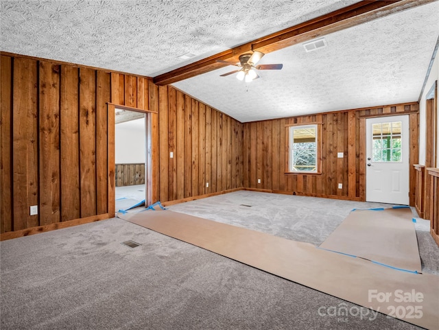 carpeted entryway with vaulted ceiling with beams, a textured ceiling, and ceiling fan