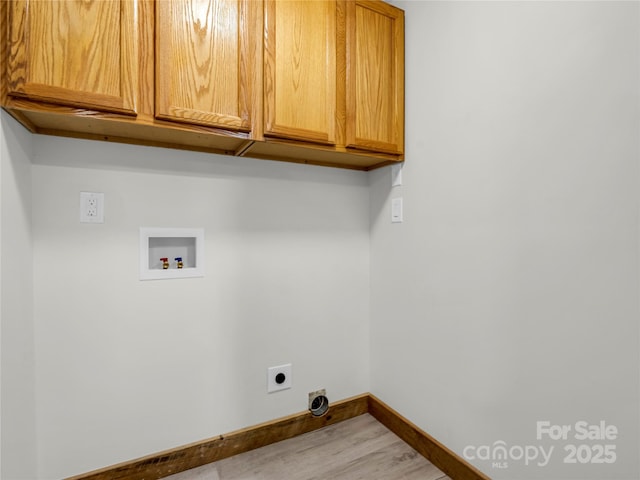 clothes washing area featuring electric dryer hookup, hookup for a washing machine, and cabinets