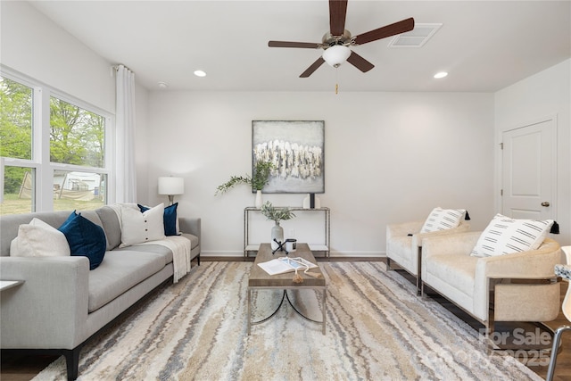 living room with hardwood / wood-style floors and ceiling fan