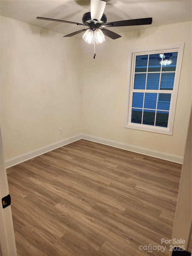 spare room with wood-type flooring and ceiling fan