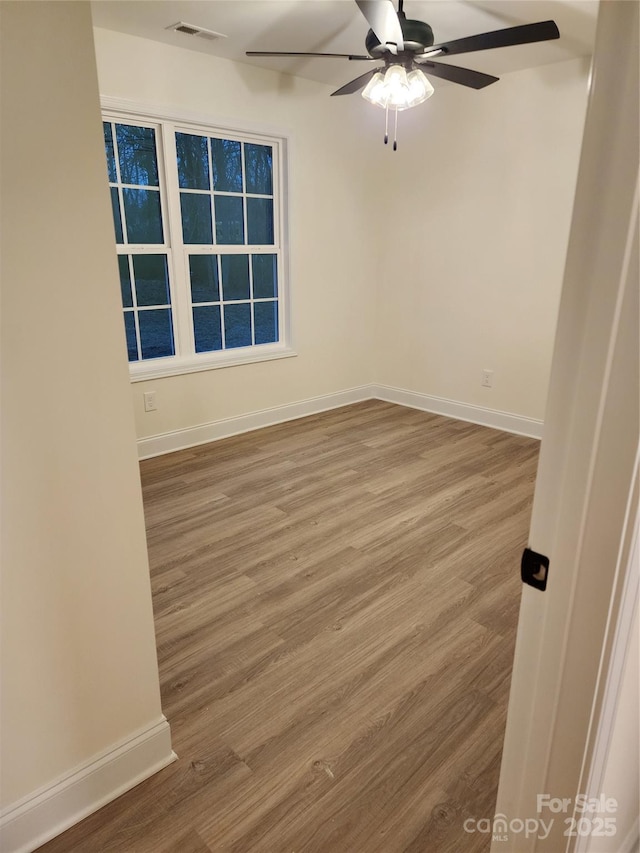 unfurnished room featuring hardwood / wood-style floors and ceiling fan