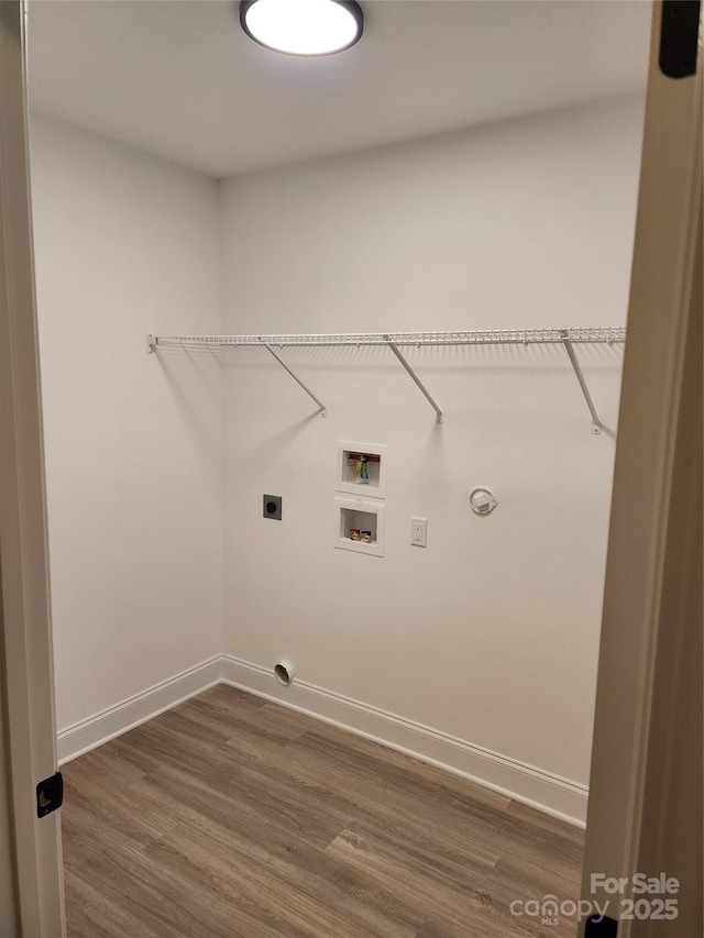 laundry room featuring hardwood / wood-style flooring, electric dryer hookup, gas dryer hookup, and hookup for a washing machine