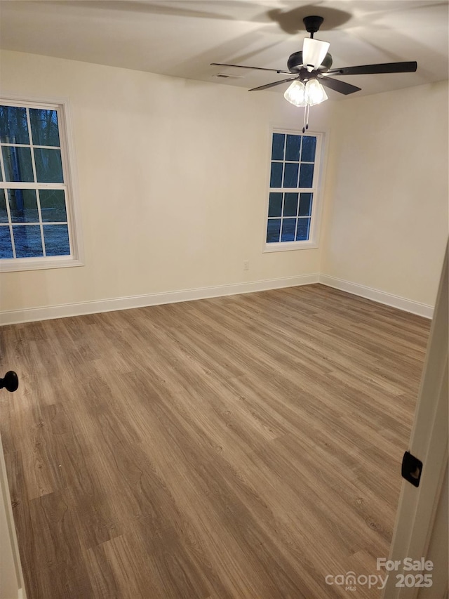 unfurnished room with ceiling fan and wood-type flooring