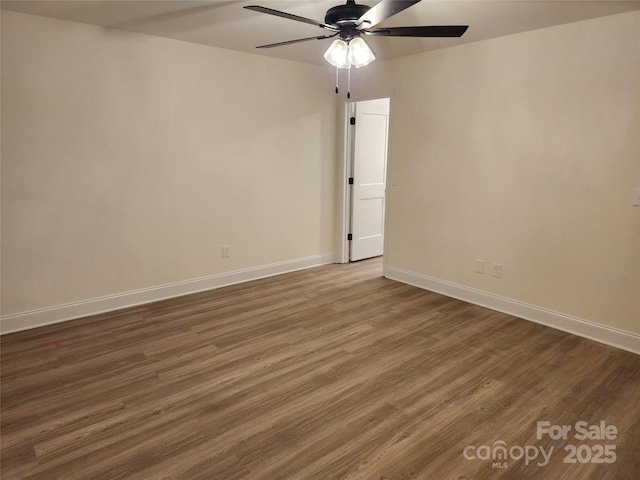 unfurnished room with dark hardwood / wood-style floors and ceiling fan