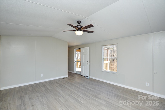 spare room with ceiling fan, lofted ceiling, and light hardwood / wood-style floors